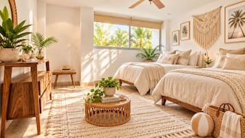 A bedroom with two beds, a ceiling fan, a large window with a view of palm trees, and a wooden floor.