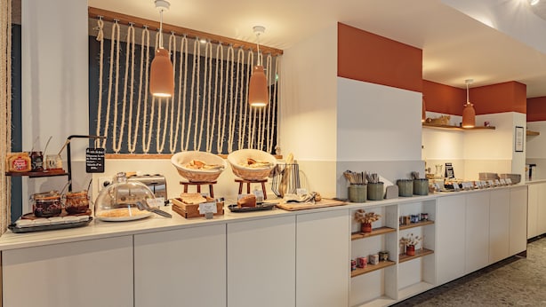 A breakfast buffet with various food items and condiments.