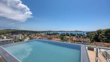 Seasonal outdoor pool, open 9:00 AM to 9:00 PM, pool umbrellas