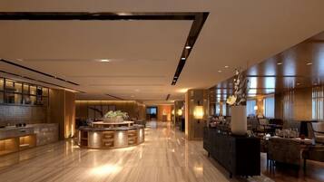 A spacious hotel lobby with a central island, seating areas, and a reception desk.