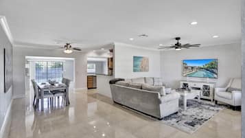 Relax in this inviting living area with a sofa, dining table, and kitchen, perfect for meals and socializing.