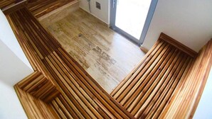 A room with wooden paneling along the walls and a tiled floor. - PONY PALACE Best Rooftop Pool in Cartagena! Beachfront, 3BR luxury condo balcony (Unknown)