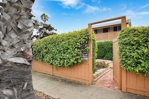 Stroll through the beautifully maintained garden, surrounded by lush foliage, to the entrance of this modern home.