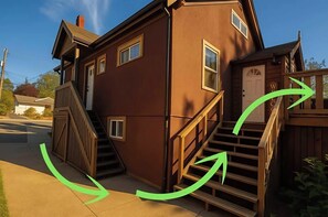 A two-story house with a wooden staircase and a front door. - Charming "Melrose Place" w Year-Round Heated Pool, Deck & Grill (Victoria)