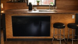 A kitchen with a wooden countertop, a black sink, and two black stools. - Charming "Melrose Place" w Year-Round Heated Pool, Deck & Grill (Victoria)