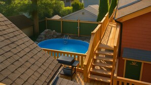 A backyard with a swimming pool, wooden deck, and a small table with chairs. - Quaint Attic Suite w/ Heated Pool (Year-Round) (Victoria)