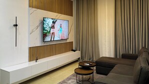 Signature Apartment | Living area | 0-inch Smart TV with satellite channels, Netflix, streaming services - The Azaria Hotel and Apartments (Lekki)