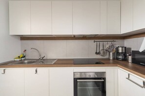 Fridge, dishwasher, high chair, cookware/dishes/utensils