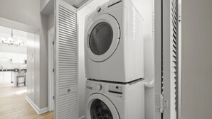 A laundry room with two stacked front-loading washing machines.