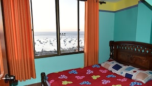 A bedroom with a bed, curtains, and a window with a view of boats on the water. - Nexus Mirasol Backpackers (Copacabana)