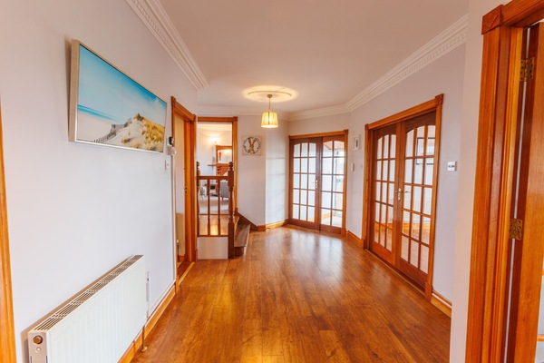 Entry hall with double french doors to dining room and double doors to the front porch