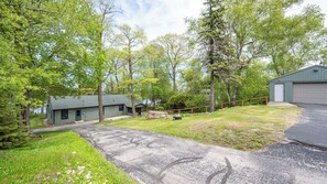 A residential property with a detached house, a garage, and a driveway.