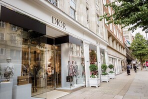 A Dior store with mannequins displaying clothing and handbags.