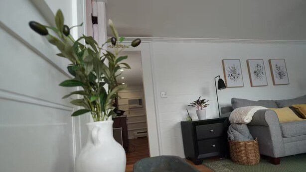 A living room with a grey sofa, a white vase with a plant, a black side table, and a grey rug. - Clean, Bright & Private WHOLE HOUSE 4 YOU. Safe, Centrally Located, Garage (New Britain)