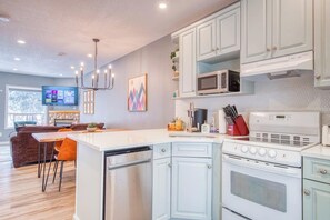 Enjoy cooking in this well-equipped kitchen with a central island, gas stove, and microwave.