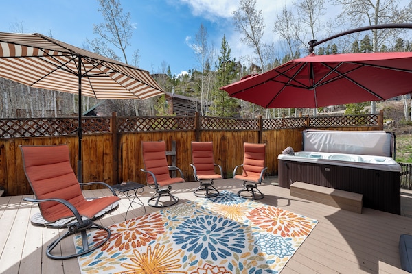 Spacious outdoor patio with private hot tub, gas grill, fire pit and plenty of seating!