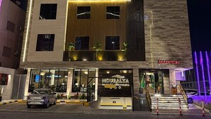A hotel with a modern facade, a reception area, and a visible entrance. - Nouralya Serviced Apartments (Al Khobar)