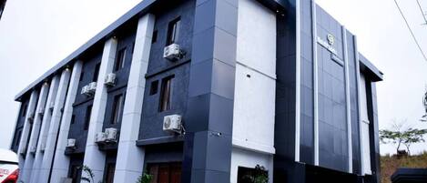 A modern building with a flat roof, multiple air conditioning units, and a clean, minimalist design.