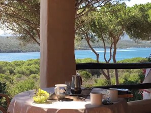 Enjoy a peaceful meal in this serene outdoor dining area overlooking the ocean.