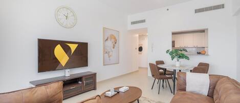 Luxury Apartment, Balcony, City View | Living area | 55-inch Smart TV with satellite channels