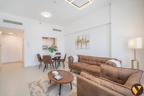 Luxury Apartment, Balcony, City View | Living area | 55-inch Smart TV with satellite channels