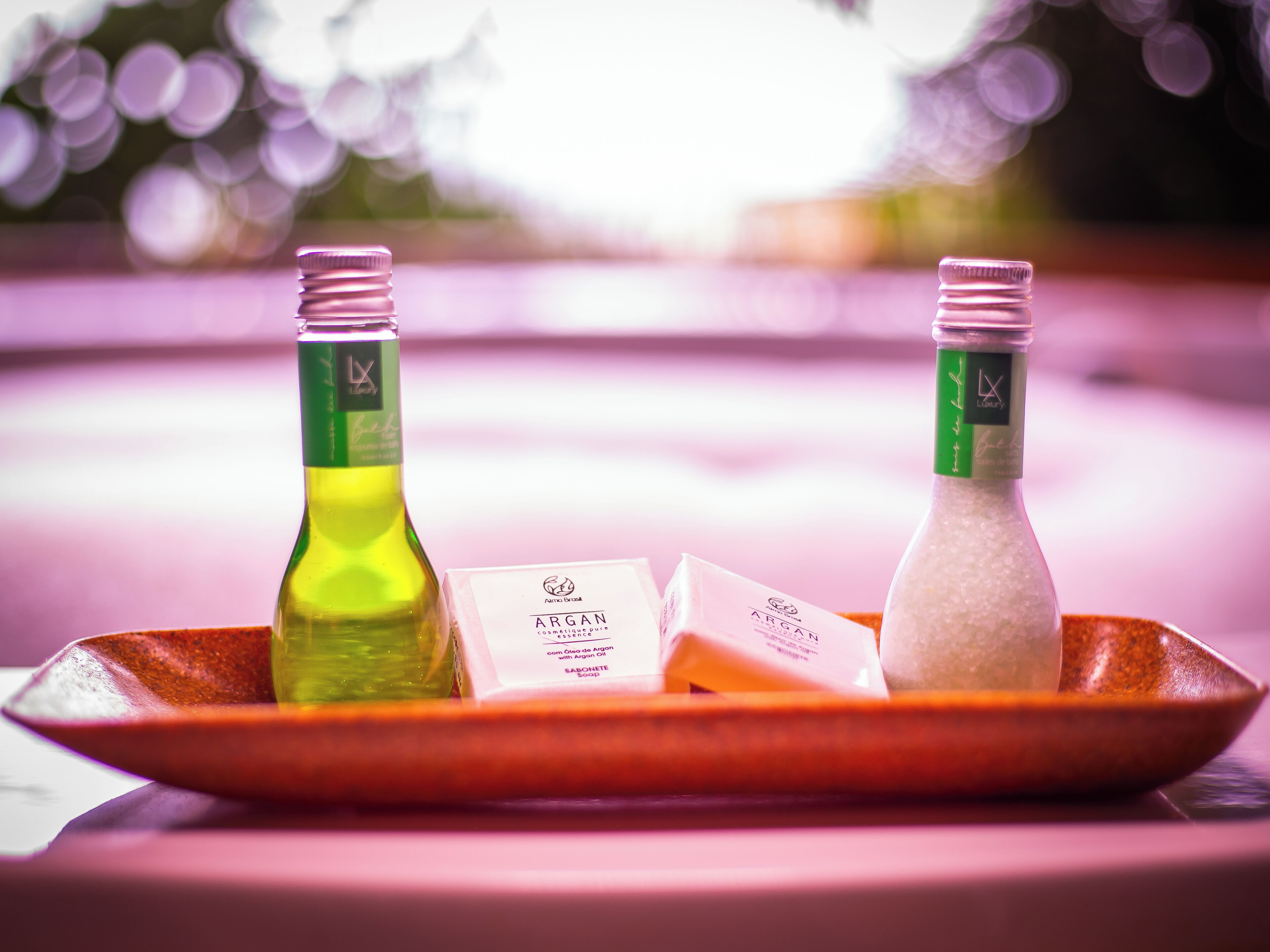 Two bottles of lotion on a tray with a soap bar.
