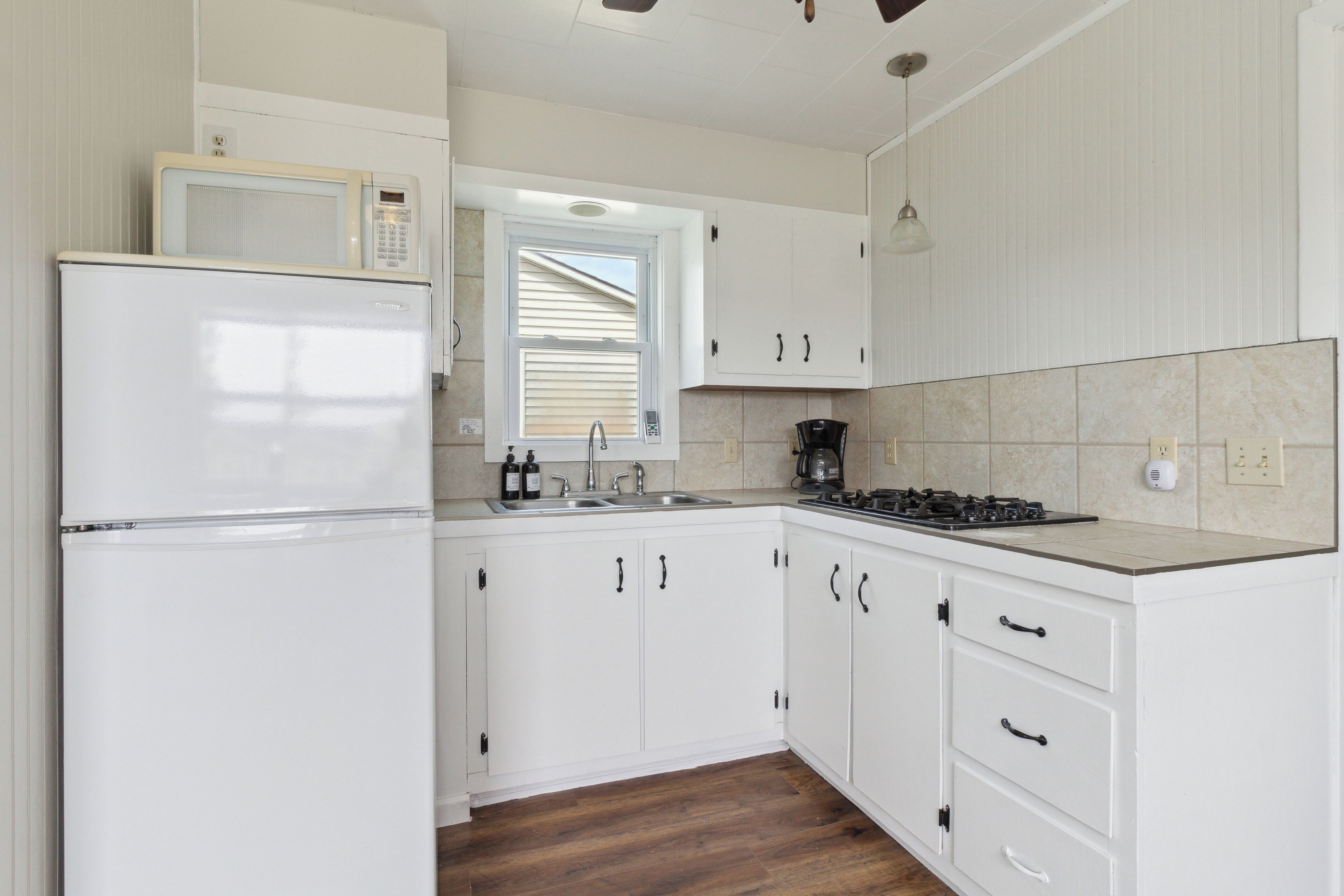 Fridge, microwave, coffee/tea maker, cookware/dishes/utensils