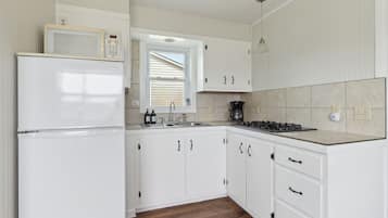 Fridge, microwave, coffee/tea maker, cookware/dishes/utensils