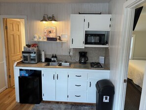 Fridge, microwave, coffee/tea maker, cookware/dishes/utensils