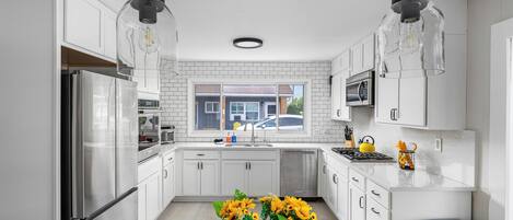 Fridge, microwave, coffee/tea maker, cookware/dishes/utensils