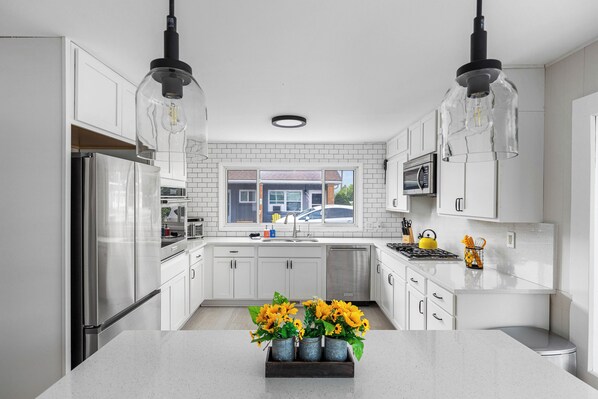 Fridge, microwave, coffee/tea maker, cookware/dishes/utensils