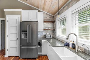 Fridge, microwave, coffee/tea maker, cookware/dishes/utensils