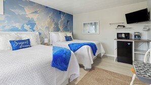 A hotel room with two beds, a TV, a refrigerator, and a microwave. - Deluxe Double Studio 6 (Arcadia)