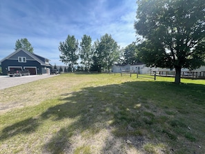 A residential area with a large house, a garage, and a fenced yard. - The Luxe King Room 2 (Arcadia)