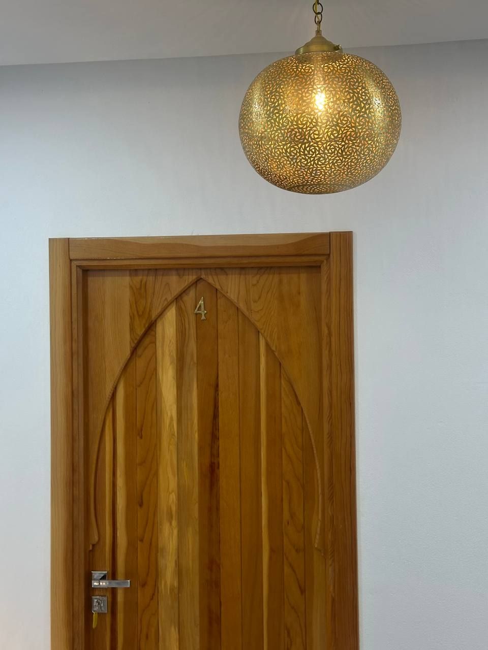 A wooden door with a number '4' and a metal handle.