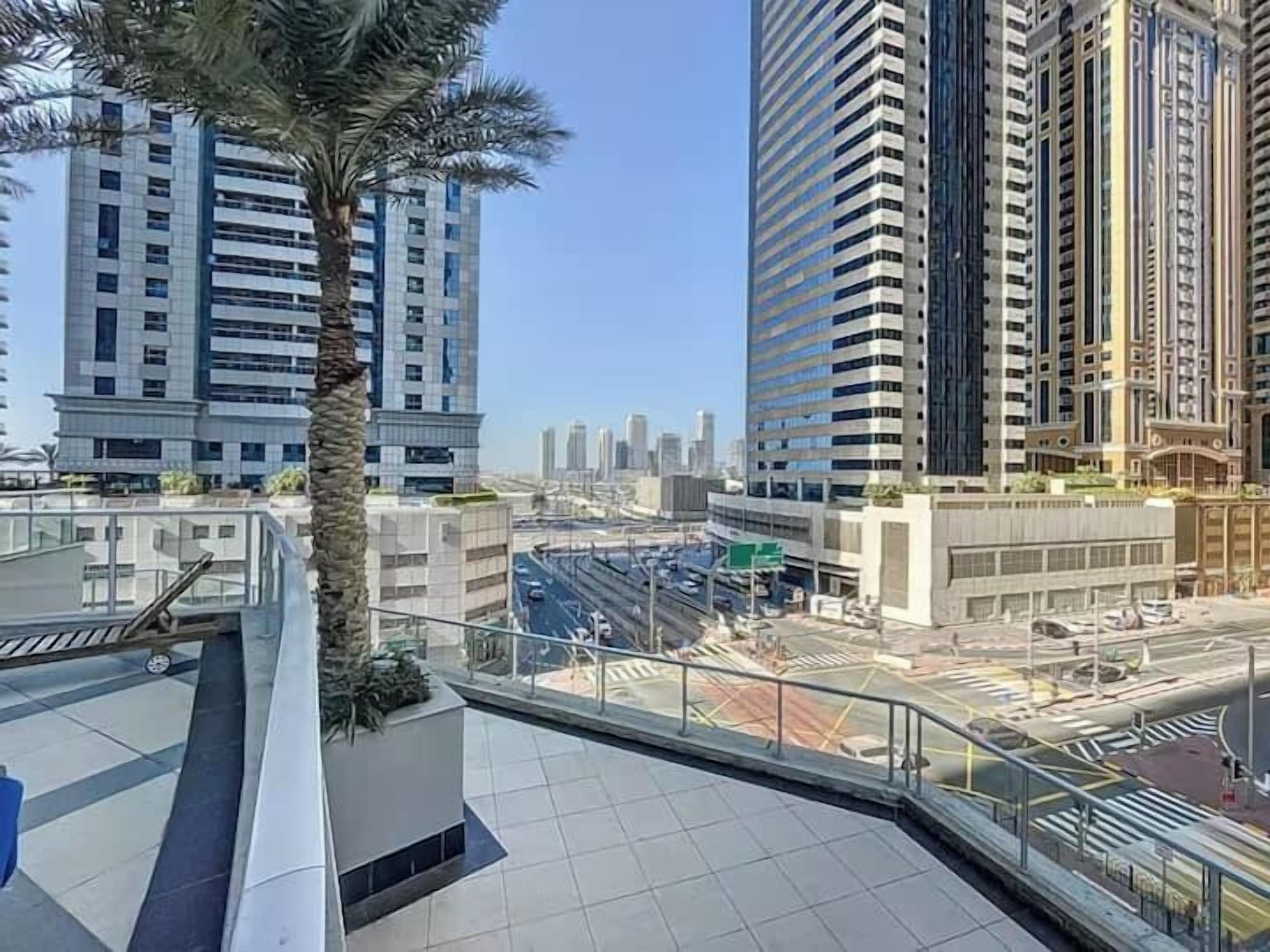 A high-rise building with a modern design, featuring multiple floors and a prominent glass facade.