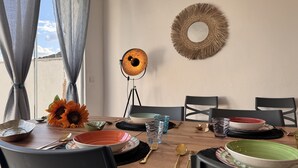 A dining table set with various dishes, a sunflower decoration, and a wall-mounted mirror.