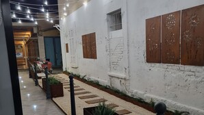 A corridor with decorative string lights, tiled flooring, and planters with greenery. - New Pescara City b&b  (Pescara)