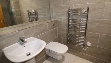 Shower, towels, soap, toilet paper