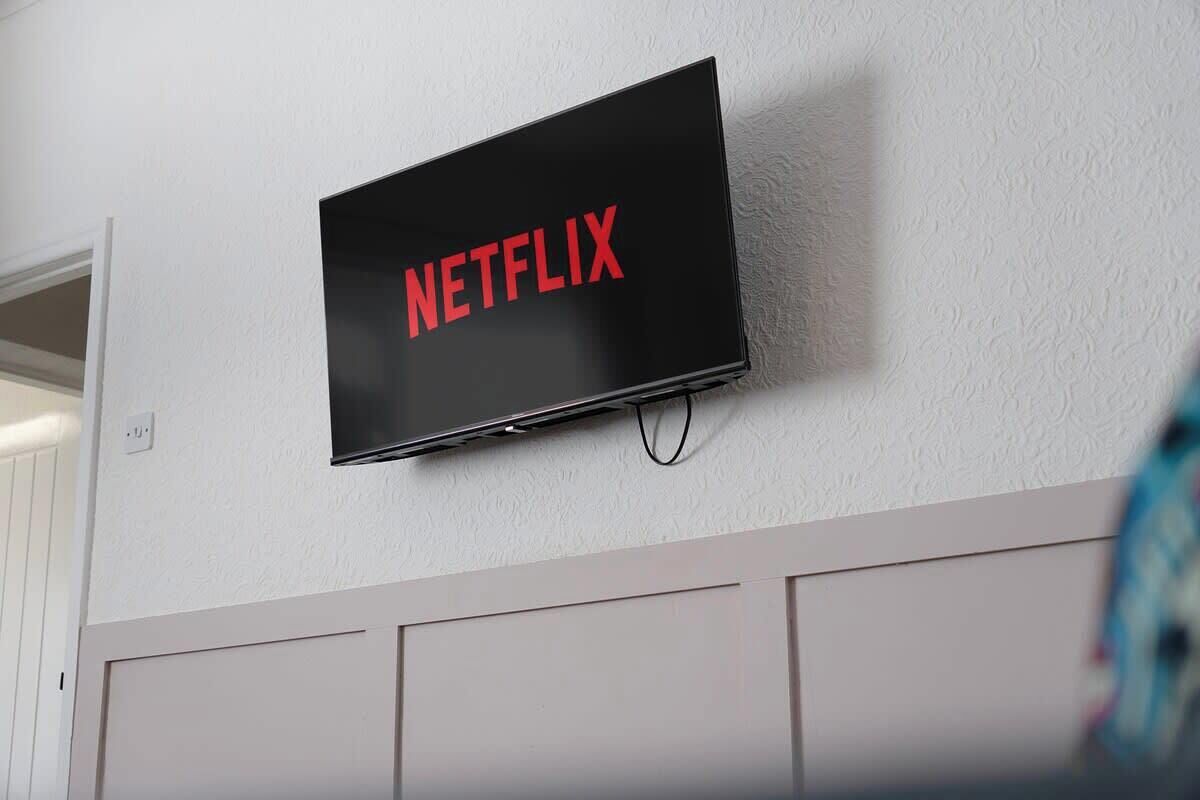 A wall-mounted television with the word 'NETFLIX' displayed in red letters.