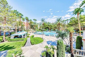 A resort pool area with palm trees, a gazebo, and a well-maintained lawn. - Dwell Descans ※ Restful Haven Steps to Vegas Strip (Las Vegas)