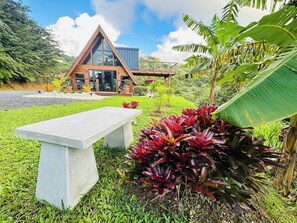 A modern building with a triangular roof, a glass facade, and a wooden deck. - Romantic Chalet Arcadia (Unknown)
