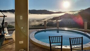 A pool with two chairs and a view of mountains and clouds. - Paradise Ciales W/ Private Climatized Pool (Ciales)