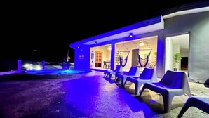 A modern building with a pool, outdoor seating, and hammocks. - Paradise Ciales W/ Private Climatized Pool (Ciales)