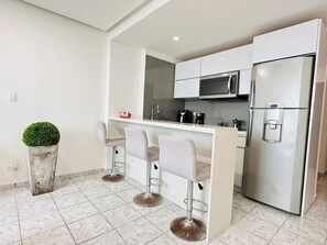 Microwave, stovetop, coffee/tea maker, cookware/dishes/utensils