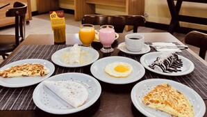 A breakfast buffet with various dishes and beverages. -  Ponta Negra Beira Mar - Pimentel (Natal)