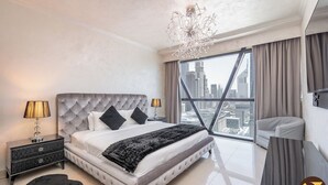 A modern bedroom with a large bed, a chandelier, a view of the cityscape, and a city skyline visible through the window. - Vogue| Park Tower DIFC near Museum of the Future (Dubai)