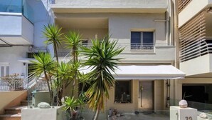 A modern two-story building with a balcony, potted plants, and a number '32' sign. - Soneto 32 Heraklion House (Heraklion)