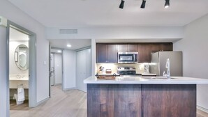 A modern kitchen with a central island, built-in microwave, oven, and refrigerator. - Hideaway 2BR Condo Pool & Heated Pool (Shanty Bay)