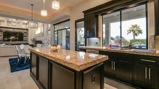 A modern kitchen with dark cabinetry, granite countertops, and pendant lighting. - Luxury Contemporary Sanctuary w/  Pool and Views! (Fountain Hills)